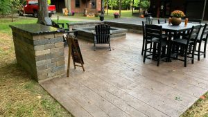 wood grain stamped concrete patio installed by Superb Concepts